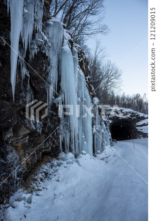 Natural icicles on a stone wall, Norway 121209015