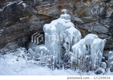 Natural icicles on a stone wall, Norway Natural icicles on a stone wall, Norway 121209016