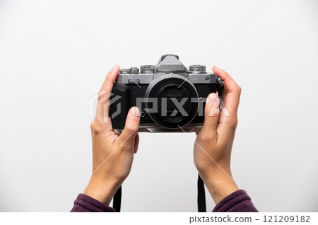 Hand holding classic retro style camera in modern assembly, on white background, front view, retro updated things concept Hand holding classic retro style camera in modern assembly, on white background, front view, retro updated things concept 121209182
