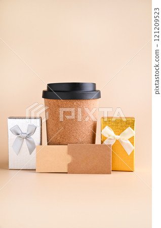 Eco-Friendly Coffee Cup with Gift Boxes Minimalist Holiday Gift Concept. tylish image featuring an 121209523