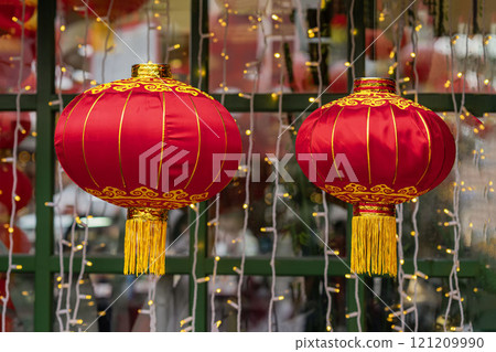 Two red traditional Chinese lanterns with golden details, decorative background Two red traditional Chinese lanterns with golden details, decorative background 121209990