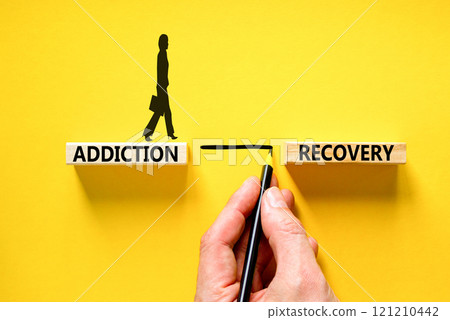 Addiction recovery symbol. Concept words Addiction recovery on beautiful wooden blocks. Psychologist icon. Beautiful yellow table yellow background. Psychology addiction recovery concept. Copy space. 121210442
