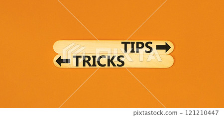 Tips and tricks symbol. Concept word Tips and tricks on beautiful wooden stick. Beautiful orange table orange background. Business and Tips and tricks concept. Copy space. Tips and tricks symbol. Concept word Tips and tricks on beautiful wooden stick. Beautiful orange table orange background. Business and Tips and tricks concept. Copy space. 121210447