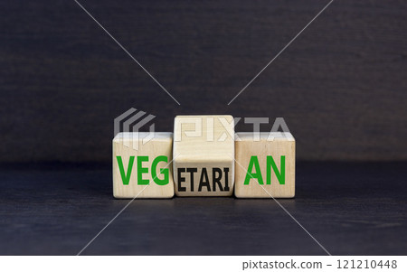 Vegetarian or vegan symbol. Concept words Vegetarian Vegan on wooden block. Beautiful black table black background. Healthy lifestyle vegetarian or vegan concept. Copy space. 121210448