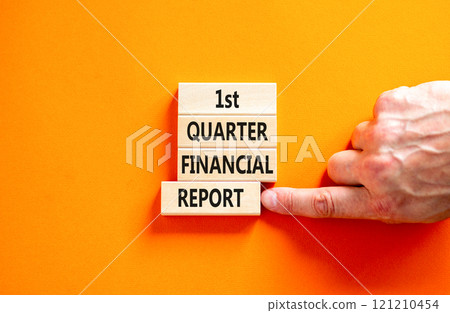 1st quarter financial report symbol. Concept words 1st quarter financial report on beautiful wooden blocks. Beautiful orange background. Business 1st quarter financial report concept. Copy space. 121210454