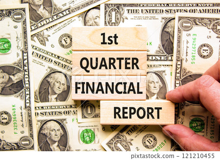 1st quarter financial report symbol. Concept words 1st quarter financial report on beautiful wooden blocks. Beautiful dollar background. Business 1st quarter financial report concept. Copy space. 121210455