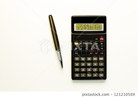 Investment symbol. Concept word Investment on beautiful black calculator. Beautiful white paper background. Beautiful black pen. Business investment concept. Copy space. 121210589