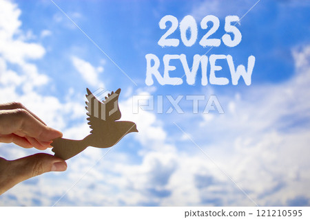 Planning 2025 review new year symbol. Concept words 2025 Review on beautiful blue sky. Beautiful blue sky clouds background. Hand with wooden bird. Business 2025 review new year concept. Copy space. Planning 2025 review new year symbol. Concept words 2025 Review on beautiful blue sky. Beautiful blue sky clouds background. Hand with wooden bird. Business 2025 review new year concept. Copy space. 121210595