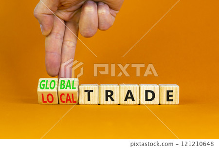 Global or local trade symbol. Concept words Global trade Local trade on beautiful wooden blocks. Beautiful orange background. Businessman hand. Business Global or local trade concept. Copy space 121210648