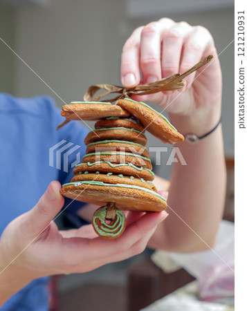 Assembling Christmas gingerbread bell 121210931