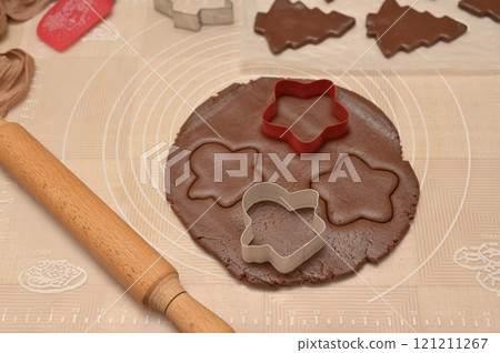 Christmas homemade baking, dough cut for baking gingerbread, cutter, rolling pin, spatula on the table 121211267