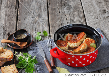 turkey potato cakes in a red pot, top view 121211734