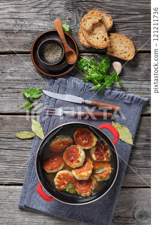 turkey potato cakes in a red pot, top view 121211736