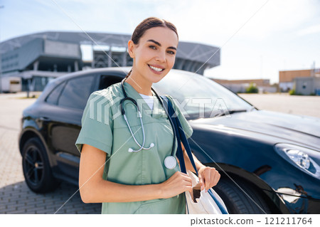 Smiling pretty young nurse with a bag on her way to the patient Smiling pretty young nurse with a bag on her way to the patient 121211764