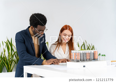 Colleagues in the office working together and looking involved Colleagues in the office working together and looking involved 121211779
