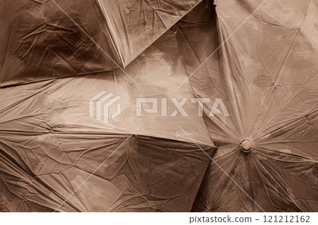 Closeup of overlapping wrinkled umbrellas in monochrome sepia 121212162