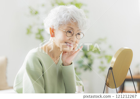 Senior woman watching a mirror Senior woman watching a mirror 121212267