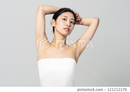 Image of a young woman wearing a tube top having hair removal Image of a young woman wearing a tube top having hair removal 121212276