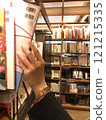 Woman's hand picking up a book in a bookstore 121215335