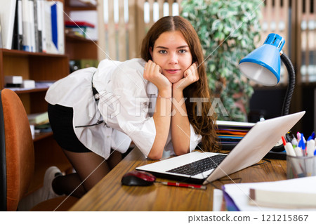 Portrait of a charming girl in company office Portrait of a charming girl in company office 121215867