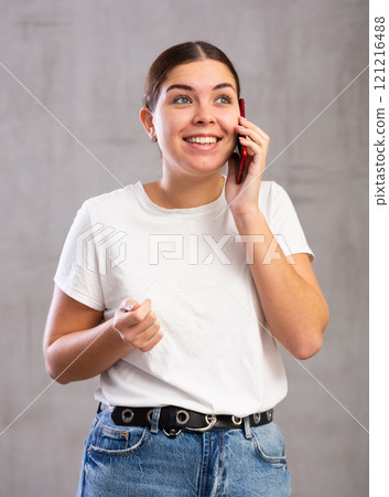 Smiling young woman talking on mobile phone 121216488