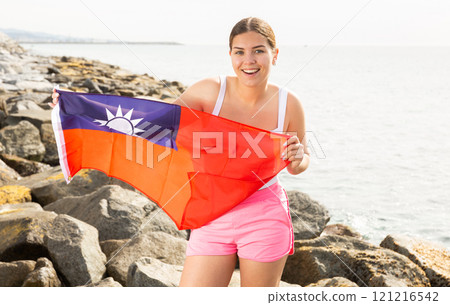 Young woman on coast posing with Taiwan flag Young woman on coast posing with Taiwan flag 121216542