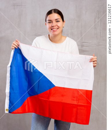 Portrait of an upset girl holding Czech flag in her hands 121216617