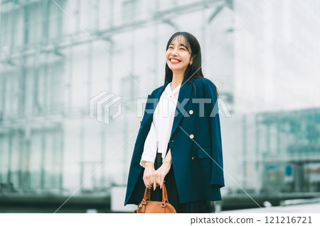 Businesswoman with office building in the background Businesswoman with office building in the background 121216721