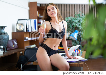 Sexy young businesswoman in bra and panties posing with office 121216936