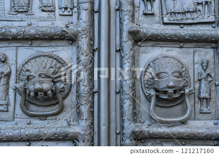 Fragment of Sigtuna gates. Bronze doors in St. Sophia Cathedral in Novgorod. Door handles are shaped like animal masks with two headed snakes attached to them. Heads of sinners are in their mouths. Fragment of Sigtuna gates. Bronze doors in St. Sophia Cathedral in Novgorod. Door handles are shaped like animal masks with two headed snakes attached to them. Heads of sinners are in their mouths. 121217160