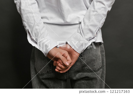 His hands are folded behind his back. gesture His hands are folded behind his back. gesture 121217163