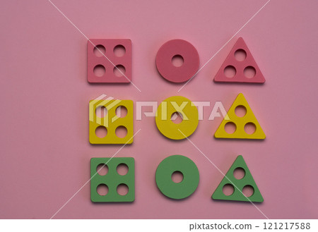 square is lined with colorful wooden geometric shapes - triangles, squares and circles. 121217588