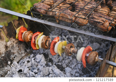 Skewer with vegetables and mushrooms on the grill. 121217589
