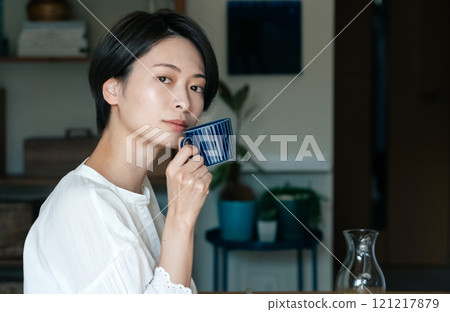 A woman drinking coffee 121217879