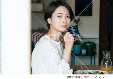 A woman drinking coffee 121217880