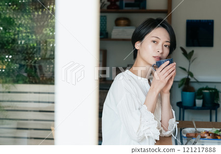 A woman drinking coffee 121217888