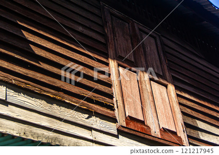 Wooden window of an old house 121217945