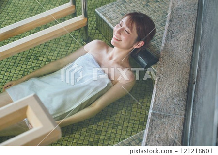 A young woman relaxing in an open-air bath. Photo courtesy of Shiratama no Yu Izumi Kei 121218601