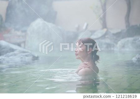 A young woman relaxing in an open-air bath. Photo courtesy of Shiratama no Yu Izumi Kei 121218619