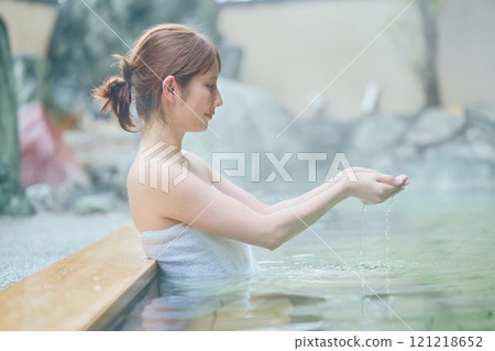 A young woman relaxing in an open-air bath. Photo courtesy of Shiratama no Yu Izumi Kei 121218652