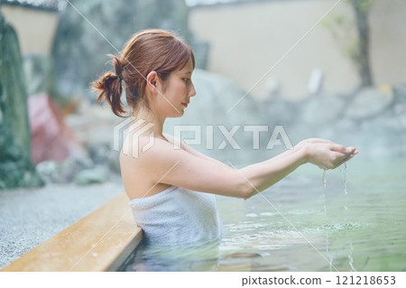 A young woman relaxing in an open-air bath. Photo courtesy of Shiratama no Yu Izumi Kei A young woman relaxing in an open-air bath. Photo courtesy of Shiratama no Yu Izumi Kei 121218653