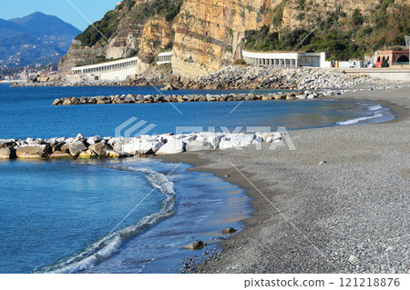 Breakwater on Mediterranean beach. Nature of sea and mountains. Sestri Levante, Liguria.  121218876