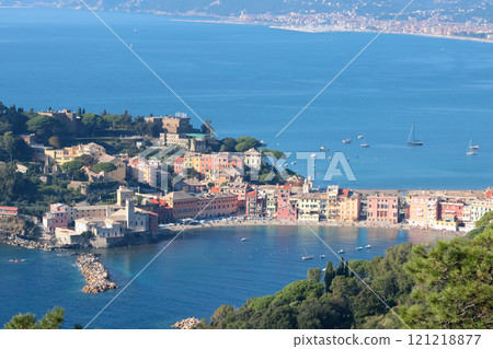 View from rock on sea, Bay of Silence, fishing cove of the town of Sestri-Levante, Italy. Tourism and recreation. Ecologically clean nature. Traditional old buildings. Historical center. 121218877