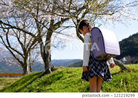 Elementary school student walking with his head down Elementary school student walking with his head down 121219299