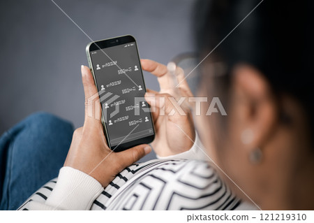 Wireless communications and social concept. Woman with smartphone with instant messaging on the screen. All screen graphics made up. Woman using instant messaging app on mobile phone. 121219310