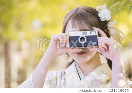 A woman in a kimono holding a film camera - Coming of Age Ceremony image 121219615