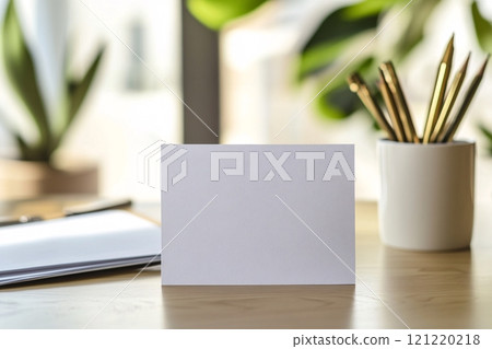 A minimalistic anniversary card rests on a tidy desk within a bright, modern office 121220218