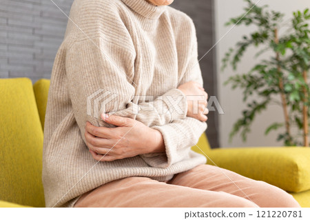 Middle-aged to senior women feeling cold in their winter rooms 121220781