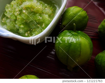 Green tomatillo fruits and salsa verde Green tomatillo fruits and salsa verde 121221763