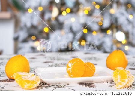 Handmade soap in the form of Orange tangerine  with bottles of dye, flavor, a block of glycerin soap base, silicone mold, on background of Christmas tree with golden light. Soap as gift new year 121222619